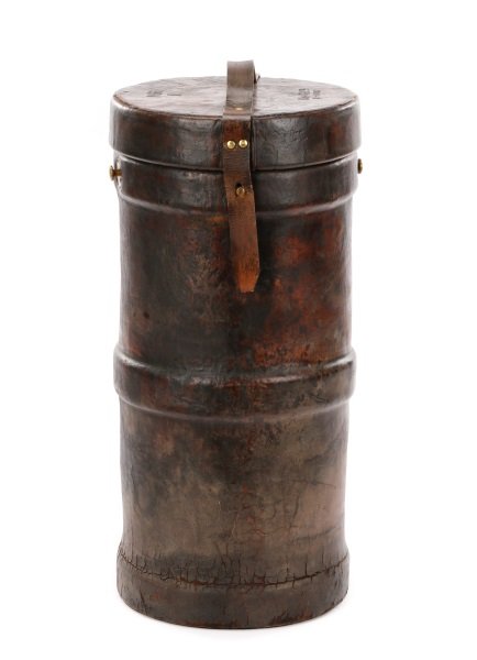 English WWII Leather Covered Explosives Case: BH & G Ltd. (English, ). A World War II leather covered cordite case of cylindrical form with lift-off hinged lid at top with leather strap handle secured by brass rivets, lined in tan burlap or linen