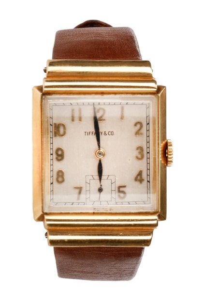 Art Deco IWC for Tiffany & Co. 14k Watch: International Watch Co. (Swiss, founded 1868-) for Tiffany & Co. (American (New York), founded 1837- ). Art Deco 14k yellow gold wristwatch with square silvered dial with raised gold tone Arabic numer