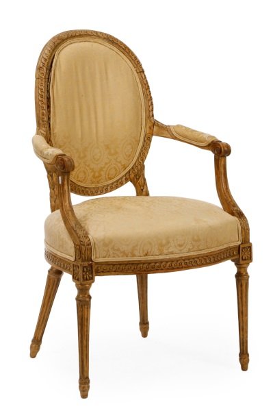 Louis XVI Period Carved Fauteuil en Cabriolet: French, late quarter 18th century. Louis XVI carved beech wood fauteuil en cabriolet having a gulloche carved oval padded back supported by berried laurel leaves to the base, the scrolled arms with ac