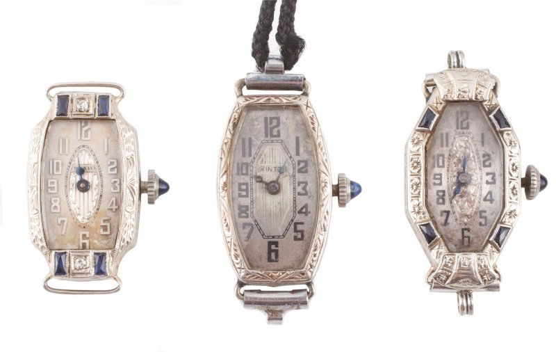 Collection of 3 Art Deco Watches, Bruner & Others: Group of three Art Deco wristwatches comprising of a P.W.C. Co. 14k white gold watch case with engraved decoration side of elongated case, accented with synthetic French cut sapphires, Arabic numerals