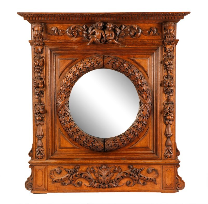 English Carved Oak Pier Mirror, L. 19th Century: English, late 19th century. Large hand carved oak wood pier mirror with cornice top with leaf tip and dentilated borders above frieze with two seated nude putti or wingless cherubs flanked by scrollin