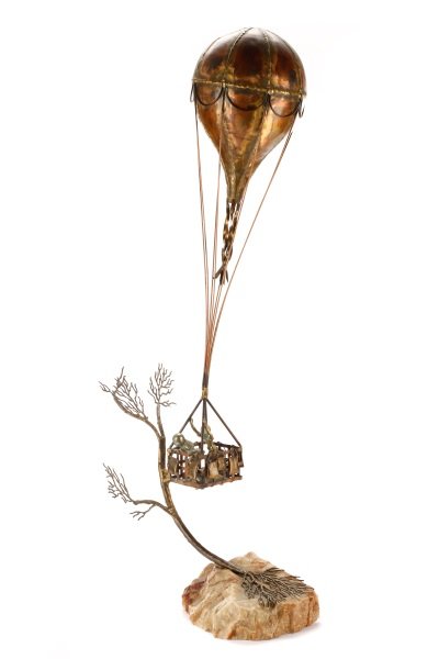 Brian Bijan, "Away We Go", Sculpture: Brian Bijan (American, 20th century), "Away We Go", mixed metals, indistinctly signed to base. Figural sculpture depicting two children in the basket of a hot air balloon, with striated stone base. Ov