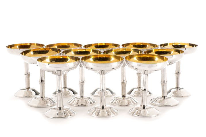 Set of 12 Spanish Silver Saucer Champagnes: Set of twelve Casa Pupo silver plate saucer champagnes having an gold interior and raised on a simulated bamboo stem. Marked to the underside "CASA PUPO SPAIN". Approximate height 5.75", diameter of m