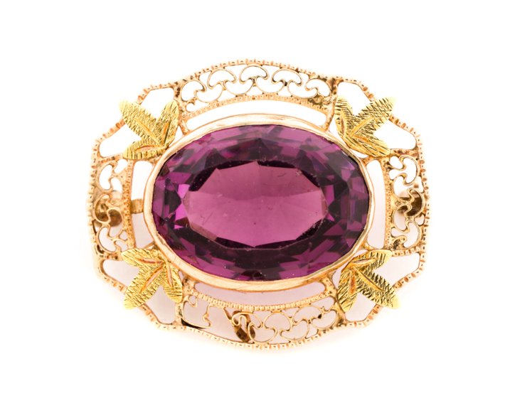 Vintage Yellow & Green Gold Pendant w/Purple Gem: A vintage 10k yellow and green gold brooch pin mounted at center with a purple glass faceted stone (12mm x 15mm), the stone surrounded by four green gold foliates linked by yellow gold filigree bands.