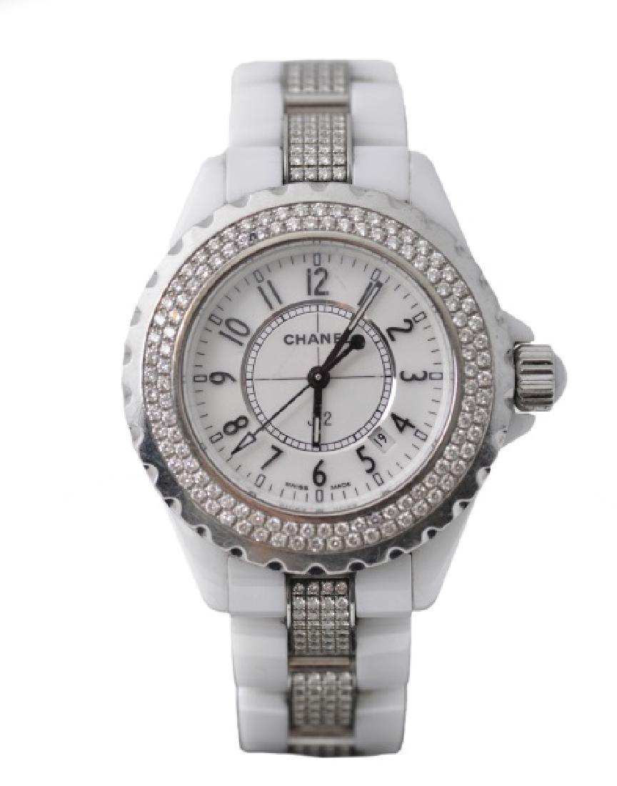 Ladies Chanel White J12 Diamond Wristwatch: Chanel (French, founded 1909). A ladies' model J12 watch, having an automatic movement, a ceramic case and bracelet, the bezel and bracelet set with diamonds (color G-H, clarity VS2). Marked with manu