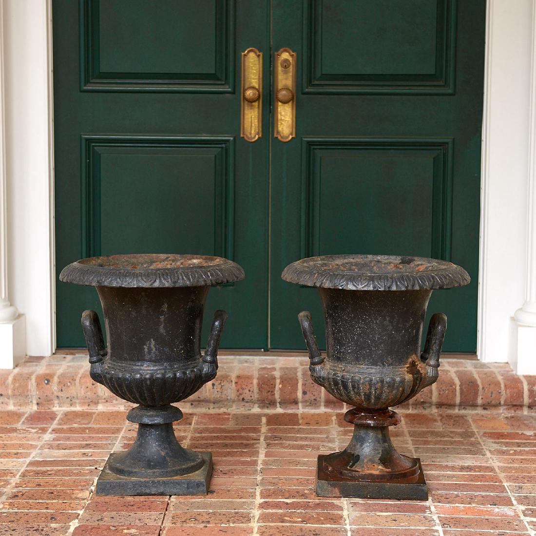 Pair old black painted cast iron garden urns: Pair old black painted cast iron garden urns, 20th c., probably American, campana form on square bases, 24"h x 20"dia. Provenance: Palmetto Hall: The Jay P. Altmayer Family Collection