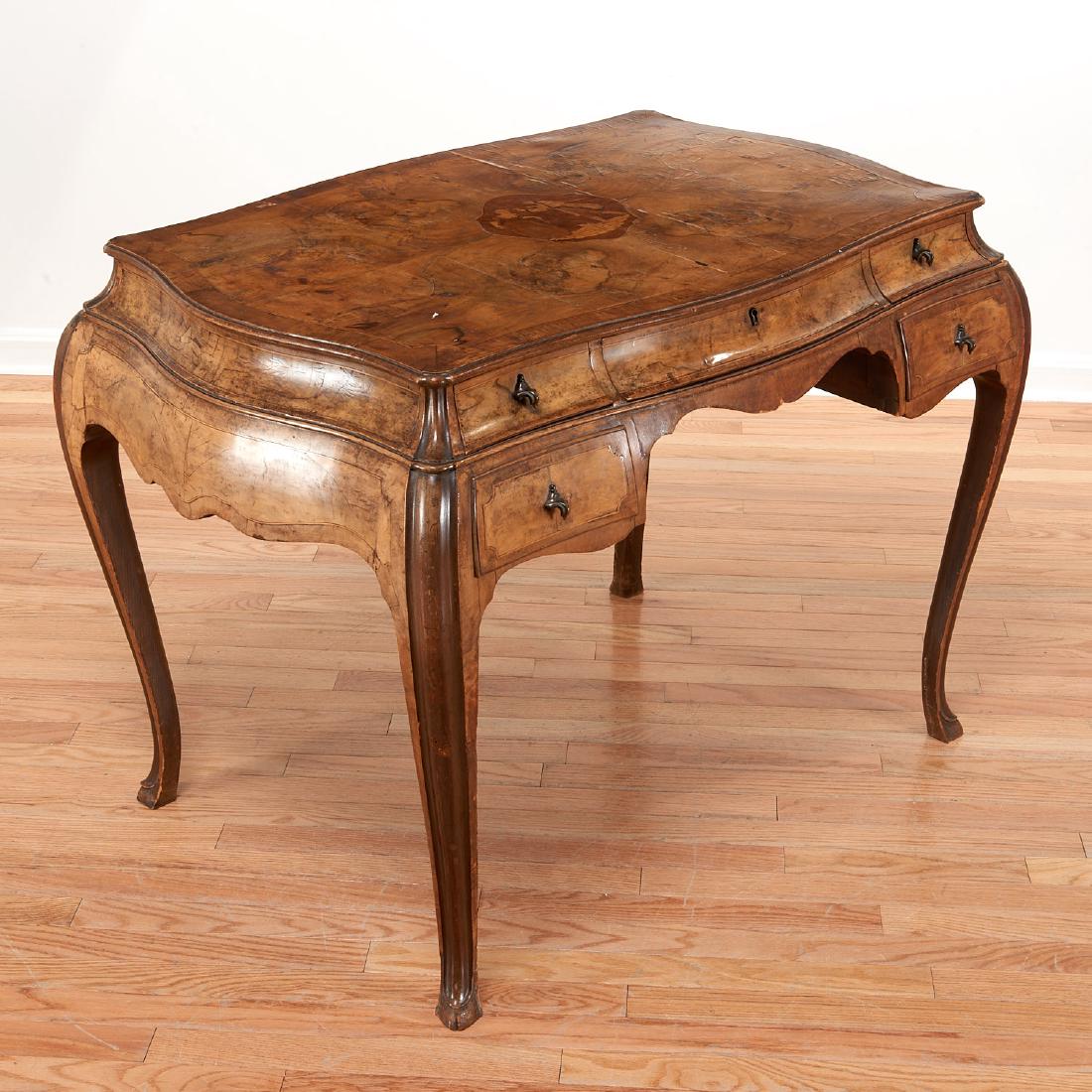 Italian Rococo inlaid olivewood bureau plat: Italian Rococo inlaid olivewood bureau plat, 19th/20th c., Italy, burl veneered top with central marquetry reserve of a courting couple, over two banks stacked drawers on cabriole legs, 30.5"h x 39"w 