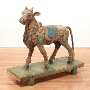 North Indian carved wood model of Nandi: North Indian carved wood model of Nandi, 19th c., possibly Rajasthan, hand-carved poly-chrome painted life size statue on wooden plinth, 37.5"h x 75"l x 13.25"w