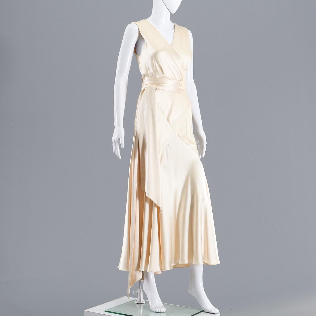 Maggie Norris Couture ivory satin gown: Maggie Norris Couture ivory satin gown, Early 2000's, bias cut, v neckline, sash at waist, side zip, 33"b, 24"w, 53"l Provenance: From a New Canaan, CT single owner clothing collection