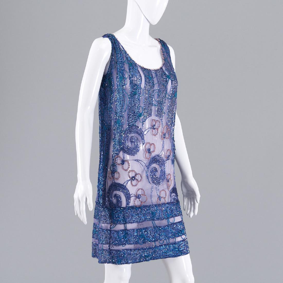 Cobalt blue and purple sequin flapper dress: Cobalt blue and purple sequin flapper dress, Circa 1920's, sheath style, purple tulle with alternating blue and turquoise sequins, open floral design to center, 34"b, 28"w, 36"l Provenance: From a New