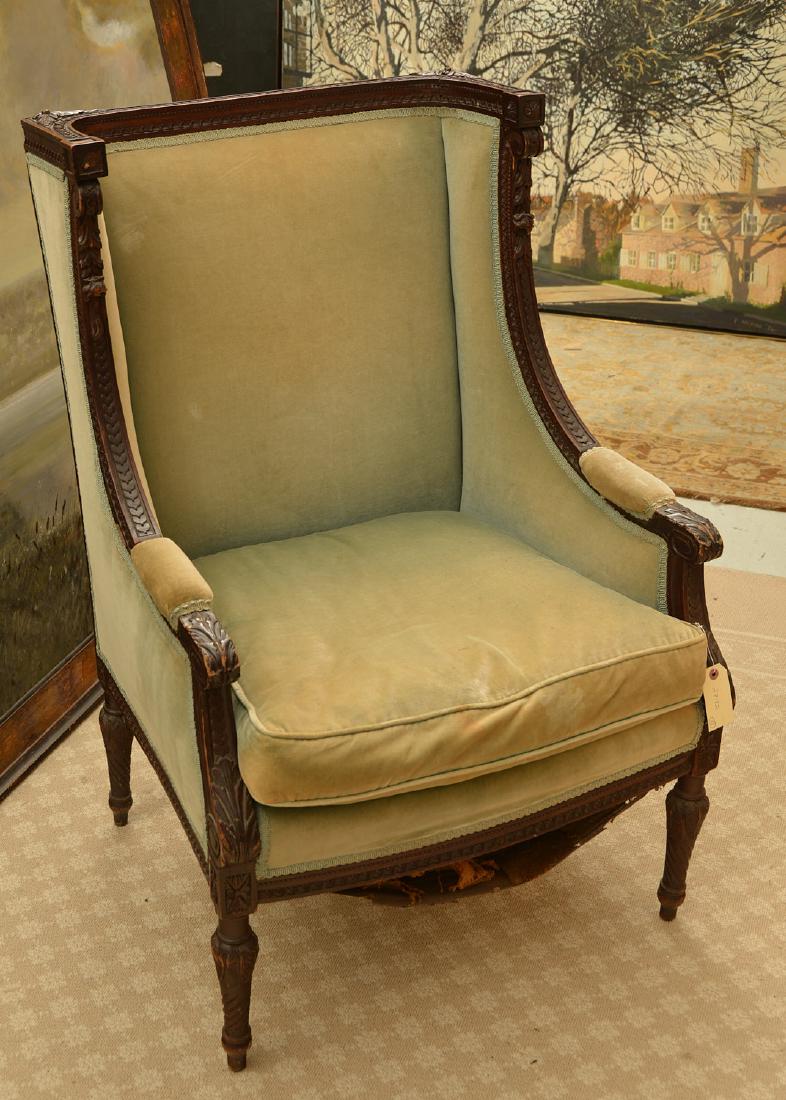 Richly carved French upholstered bergere: Richly carved French upholstered bergere, 19th/20th c., squared back, 41"h x 27.5"w x 27"d
