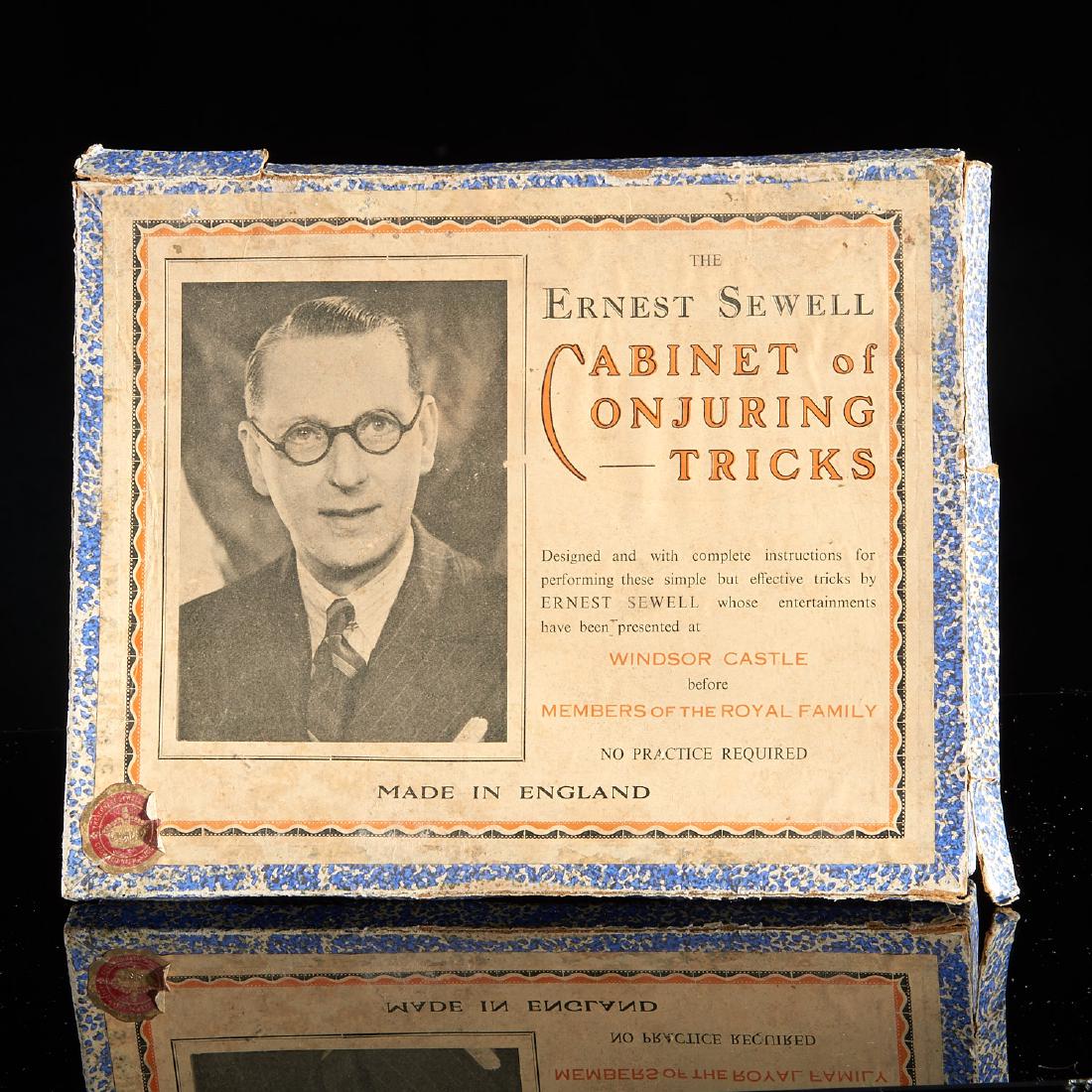 Antique magic kit: Antique magic kit, 20th c. British, boxed "The Ernest Sewell Cabinet of Conjuring Tricks" containing nested magic set, 1.5"h x 10.5"l x 8.5"w.
