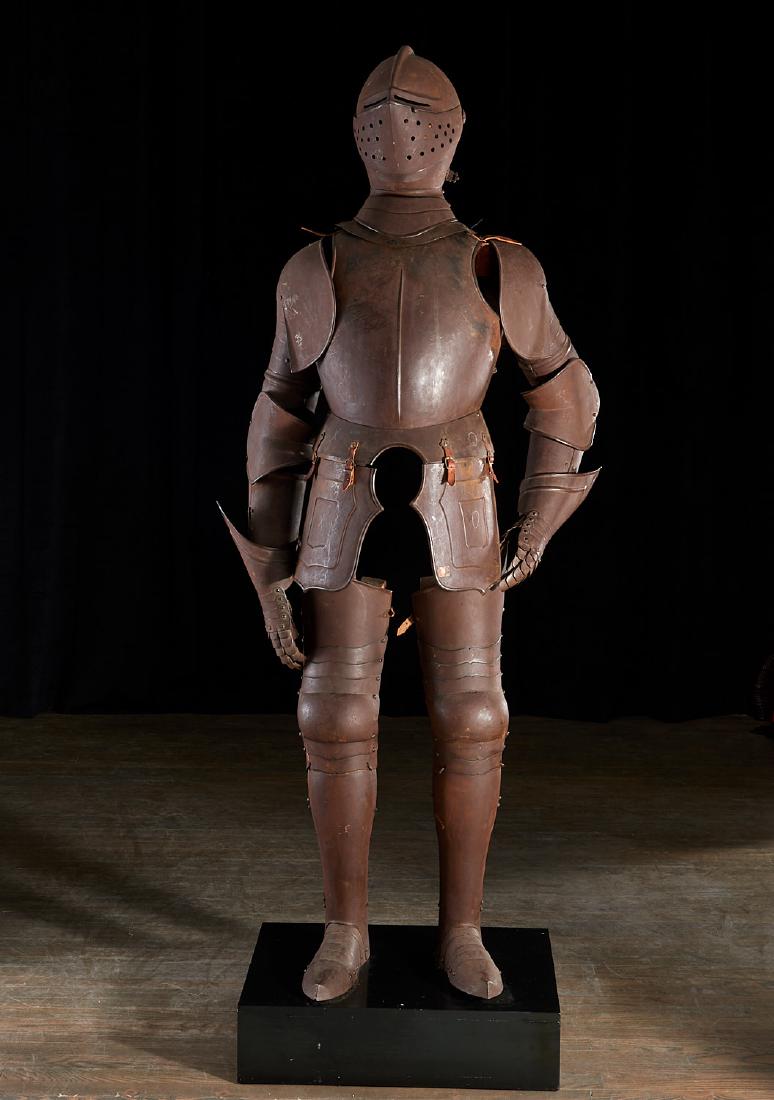 Antique Medieval style suit of armor: Antique Medieval style suit of armor, 19th/20th c., Continental, full hammered and joined metal suit of armor with leather ties, brass rivets, on wood armature mounted to base, combed helm w/ function
