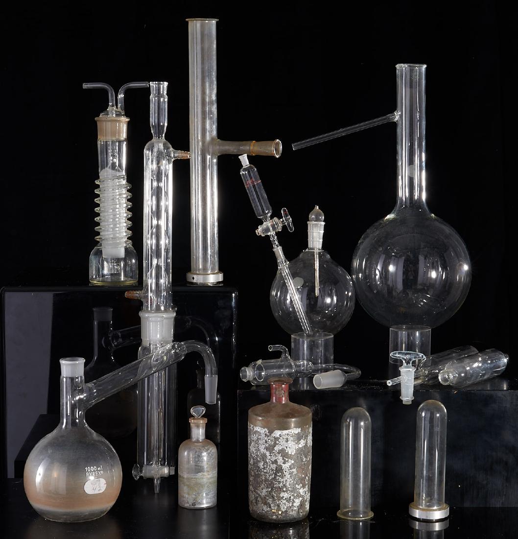 Large group (15) scientific glass vessels: Large group (15) scientific glass vessels, 19th/20th c., collection of assorted glass beakers, titration/ distillation devices and bottles, some with metal hardware, some labled "Pyrex", 16"h x 8"w x