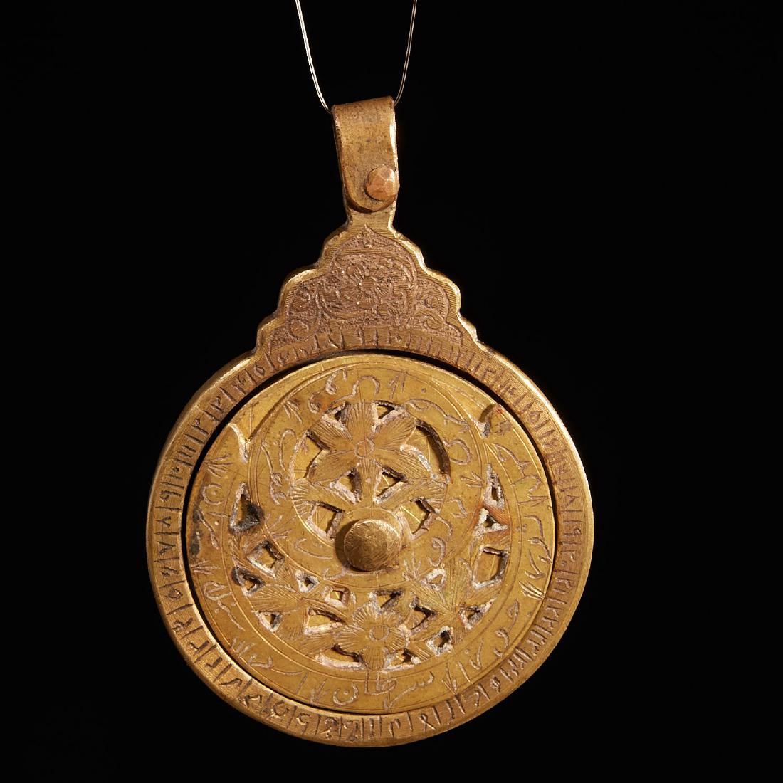 Antique Persian engraved brass astrolabe: Antique Persian engraved brass astrolabe, 19th c., circular pendant with 4 four different disc inserts that are engraved on both sides with vertical circles, azimuth angles, horizon, equator, twilight