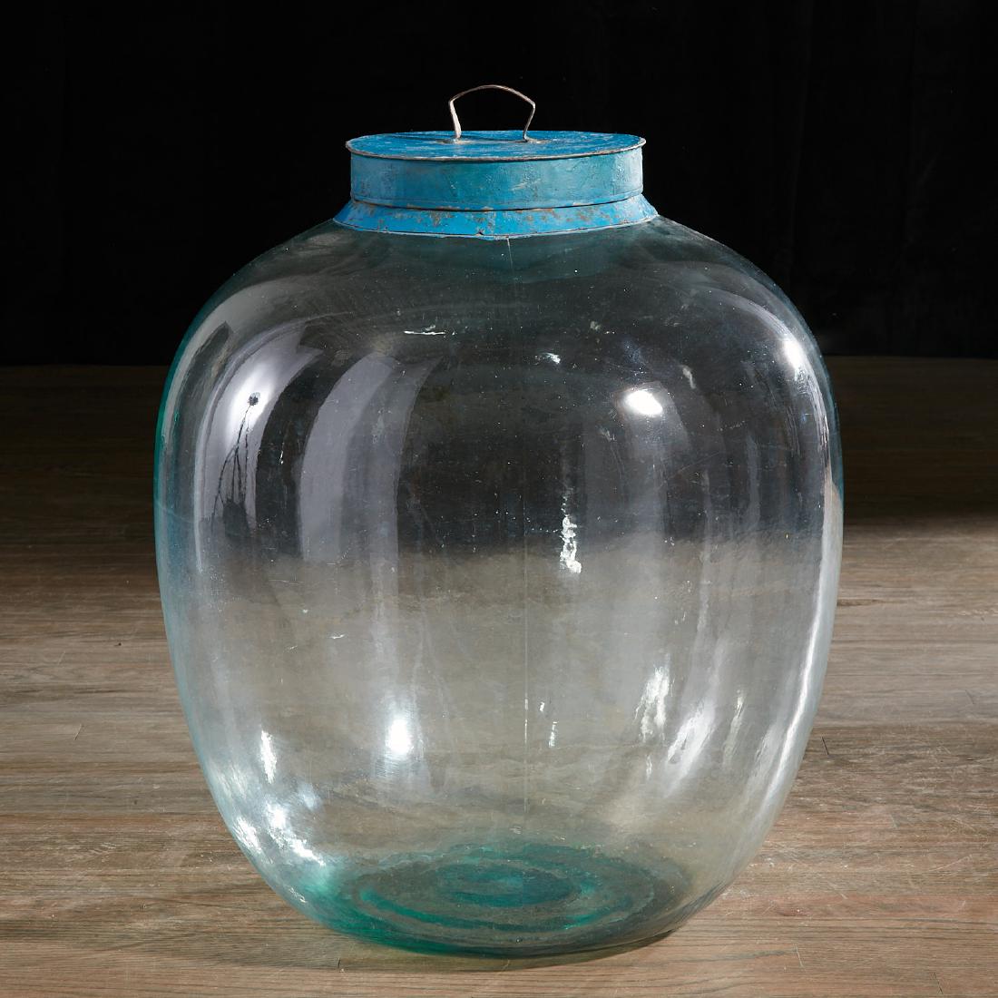 Huge glass store display jar with tole lid: Huge glass store display jar with tole lid, 19th c., globular in shape with blue painted tin lid, 21"h x 16.5"dia. Provenance: The Estate of Amy Perlin, NY