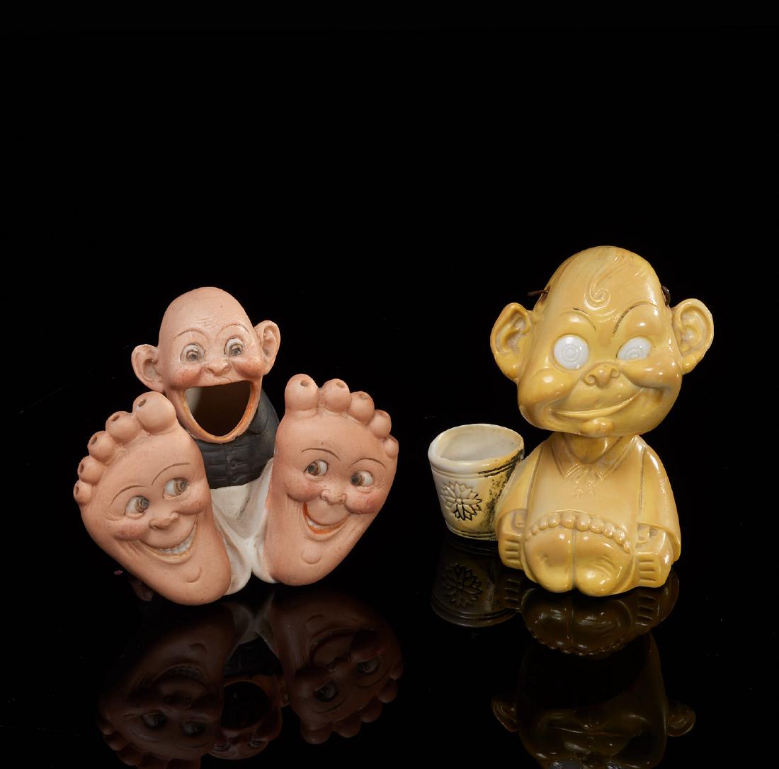 Shafer & Vater, figural match holder and nodder: Shafer & Vater, figural match holder and nodder, 1st quarter 20th c., Germany, incl. "Happy Feet" match holder and yellow glazed seated grotesque figural nodder, bisque porcelain, each with factory ma