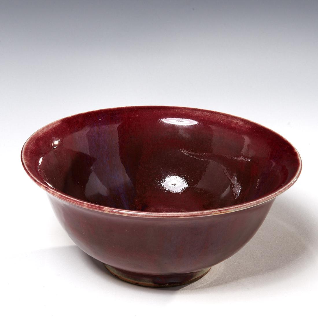 Chinese Sang de Boeuf porcelain bowl: Chinese Sang de Boeuf porcelain bowl, Qing Dynasty (19th c. or earlier), oxblood red drip glaze, 4.25"h x 9.75"dia.