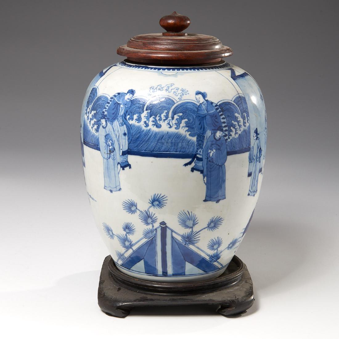 Large Chinese blue and white porcelain jar: Large Chinese blue and white porcelain jar, Qing Dynasty, decorated in the round with noblemen in various settings, with later carved wood lid and custom fitted hardwood base, empty underglaze double-