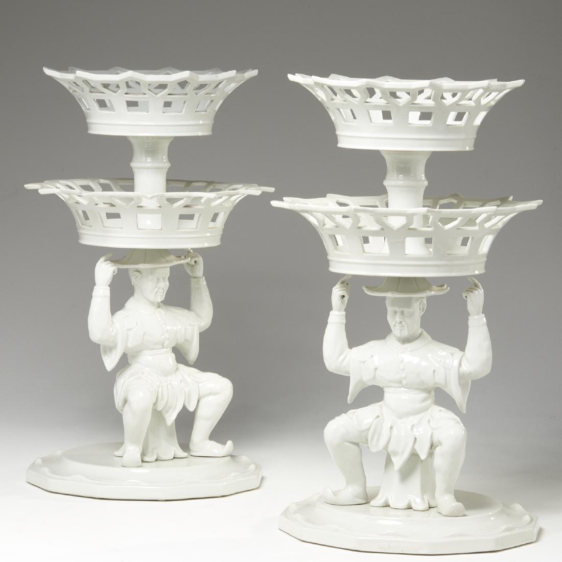 Pair Mottahedeh porcelain "Mandarin" epergnes: Pair Mottahedeh porcelain "Mandarin" epergnes, 20th c., two-tiered blanc de chine baskets above male figural base, marked "VA Portugal", to underside, 21.5"h x 12"dia.