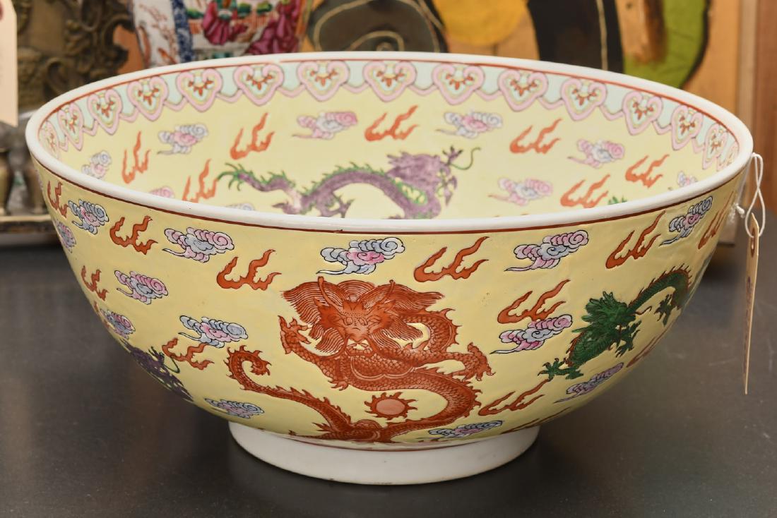 Chinese Famille Jaune dragon center bowl: Chinese Famille Jaune dragon center bowl, 20th c., red stamp mark to underside of foot, 6.5"h x 14"dia. Provenance: From a Private NYC Collection of Chinese porcelains assembled in the 1960s-1980s