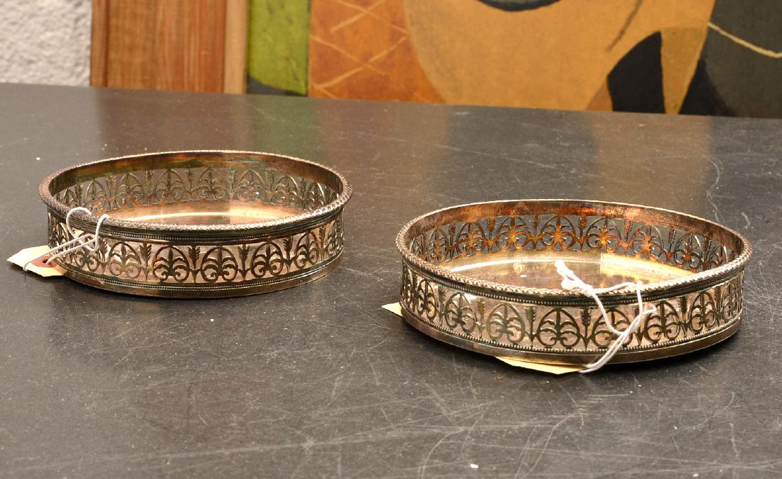 Pair French silver wine coasters: Pair French silver wine coasters, 19th c., Paris, reticulated edge with arrow design, shield emblem at center, French hallmarks, 4.25"dia., approx. 7.55ozt.
