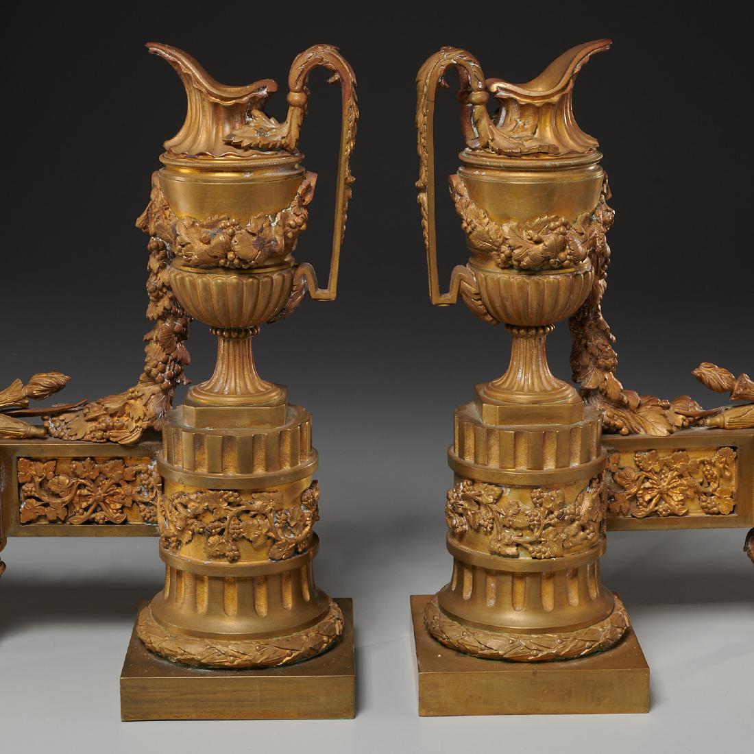 Pair Louis XVI style gilt bronze chenets: Pair Louis XVI style gilt bronze chenets, Late 19th c., France, Neo-Classical ewer andirons, fruiting vine panels, 15"h x 16"l x 5"d Provenance: Property from 168 W 86th St., NYC