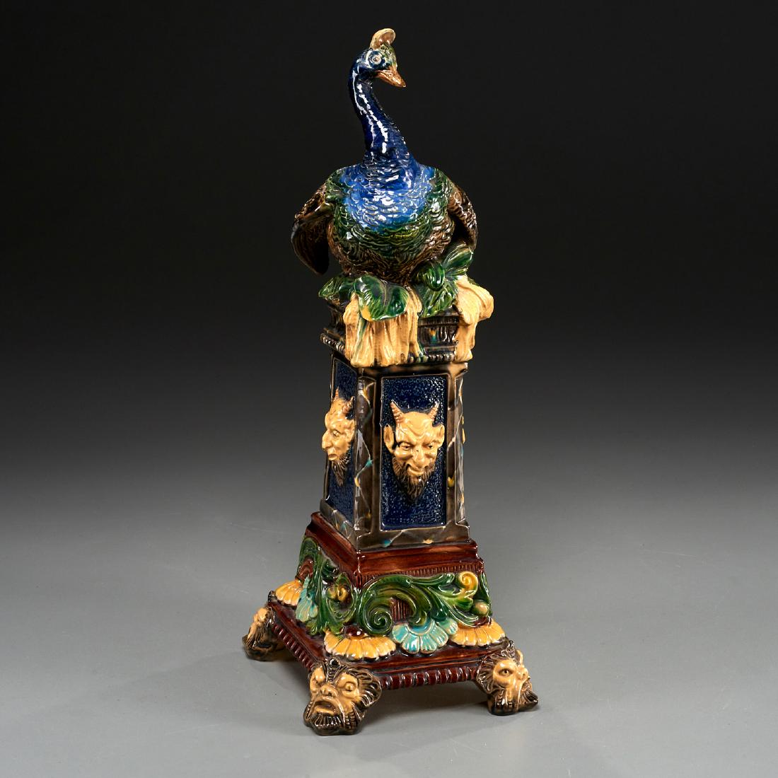 Wilhelm Schiller & Sons majolica peacock vase: Wilhelm Schiller & Sons majolica peacock vase, 19th/early 20th c., peacock perched on pedestal adorned with satyr mask heads, impressed maker's mark "WS&S" and number "384", 13.5"h x 4.5"w x 5.5"d Pro
