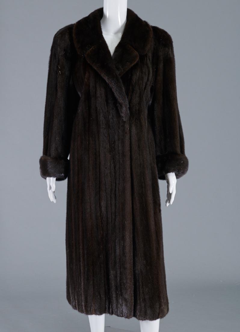 Cookchik Forrest black mink coat: Cookchik Forrest black mink coat, c. 1970's, features notched collar, cuffed sleeves, side pockets, interior lining and belt, approx. 20"sh, 22"sl, 36"b, 47"l