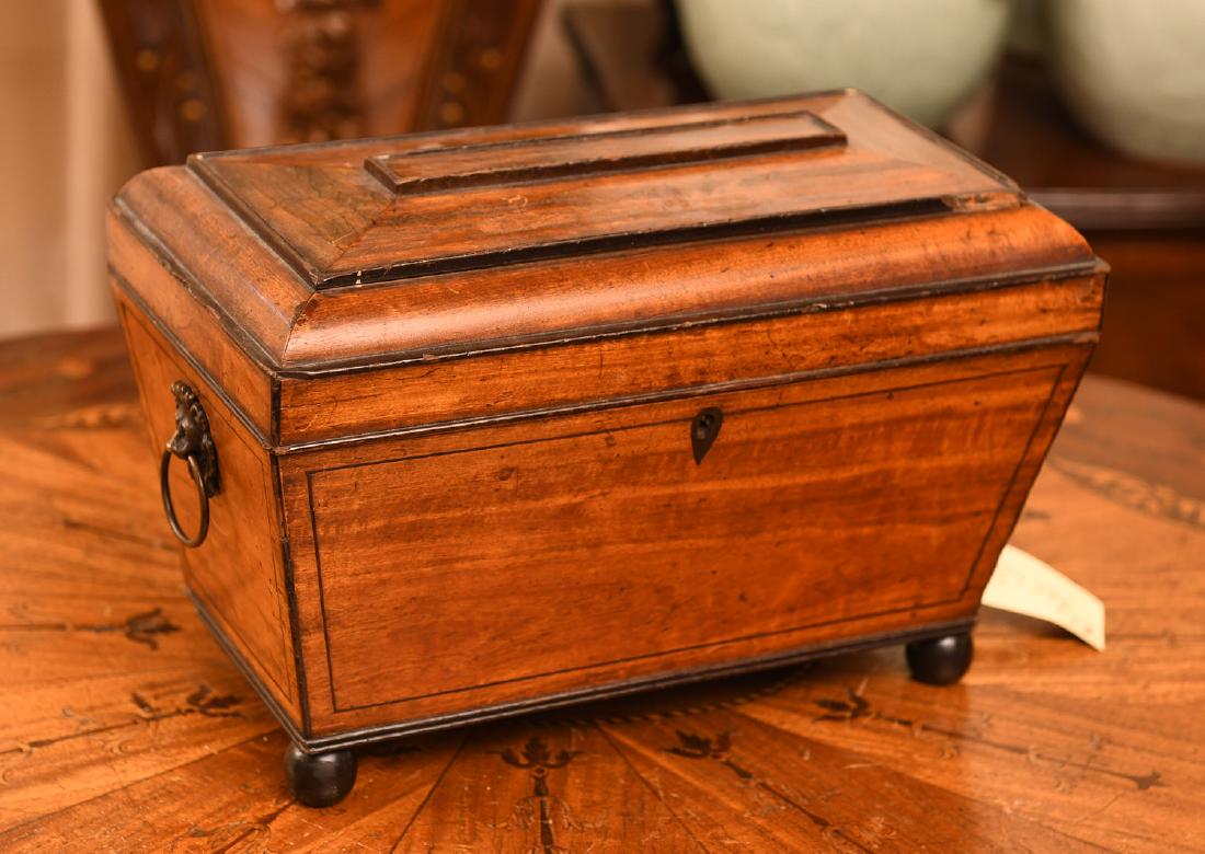 Regency mahogany caddy or humidor: Regency mahogany caddy or humidor, 19th/early 20th c., English, inlaid stringing and escutcheon, ball feet, lion ring handles, metal liner, 8.75"h x 13.25"w x 7.25"d Provenance: From the Estate of a B