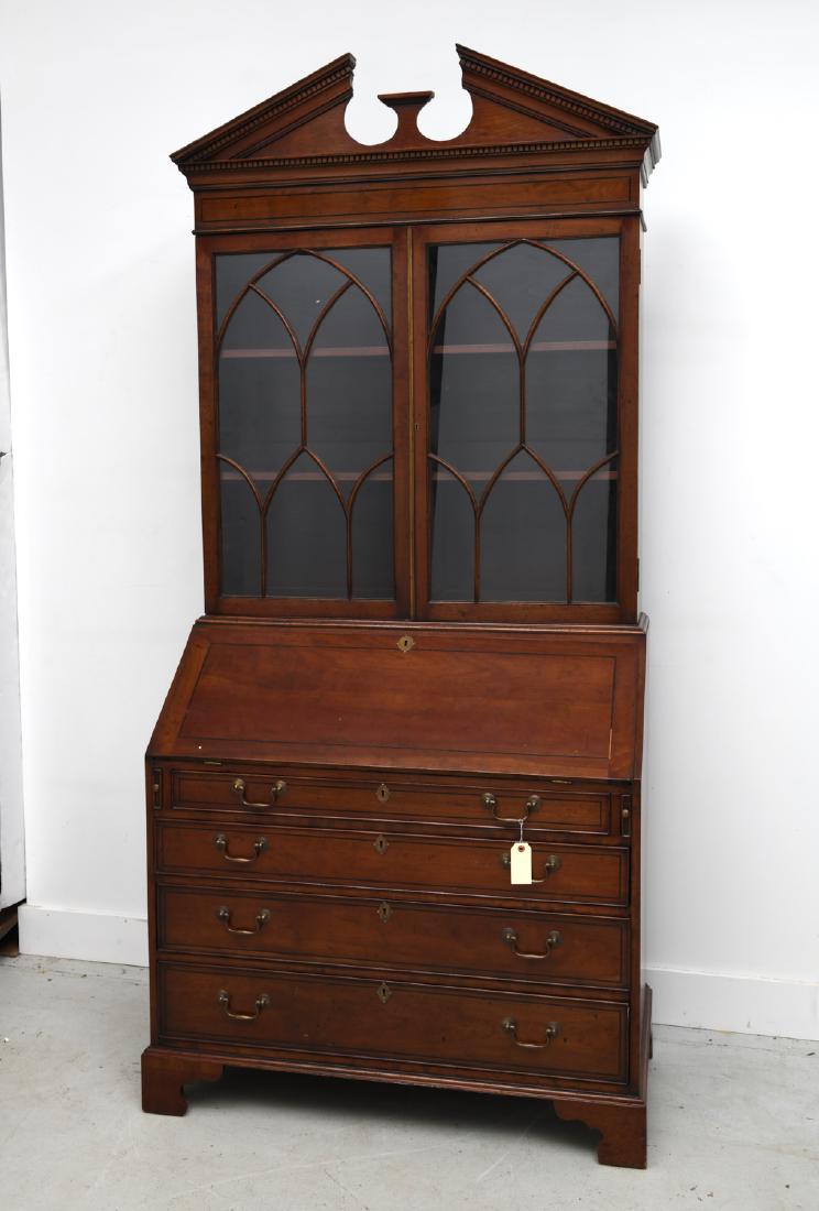 George III style mahogany secretary bookcase: George III style mahogany secretary bookcase, 20th c., open pediment top above two glazed doors, slant drop front opens to embossed green leather writing surface, cubbies, and drawer compartments, ove