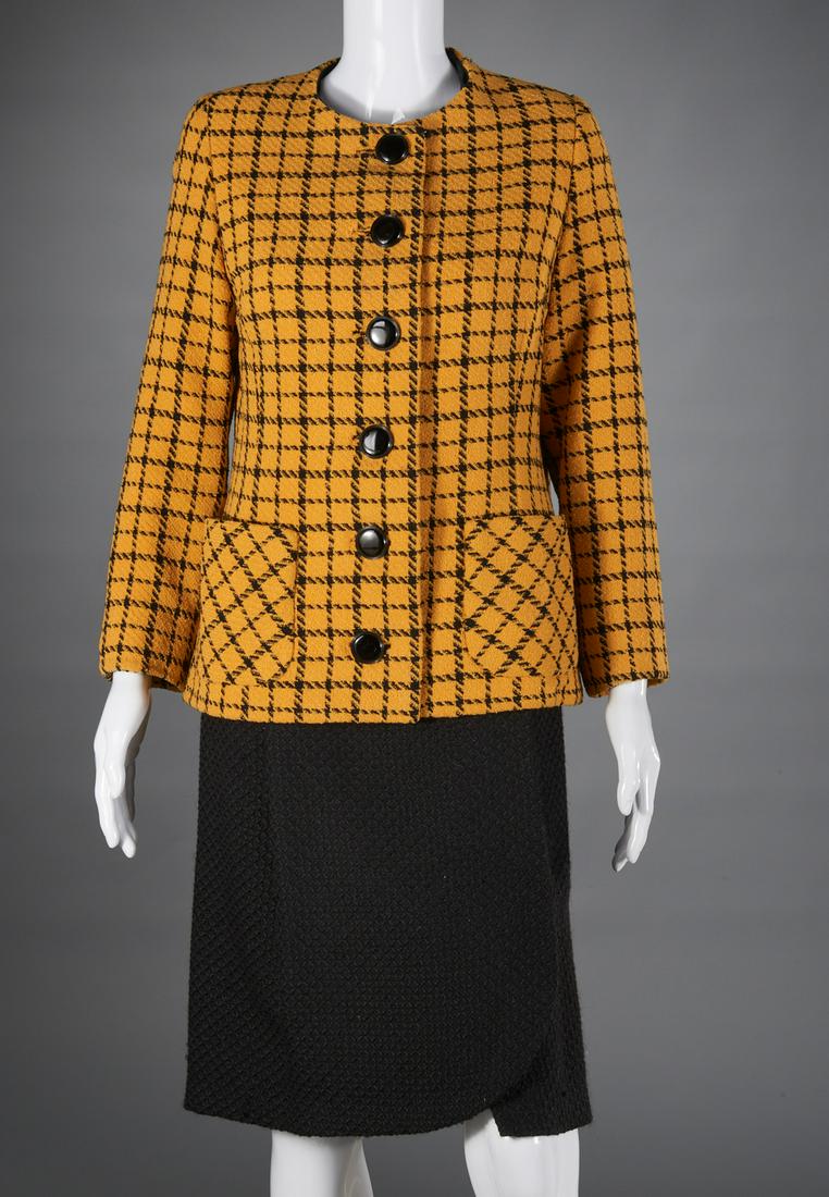 Arnold Scaasi black & yellow skirt suit: Arnold Scaasi black & yellow skirt suit, c. 1970's, yellow & black houndstooth check jacket with patch pockets, black button front, 40"b, 15"sh, 22"sl, 24"l, slim black skirt, 34"w, 24"l Provenance: F