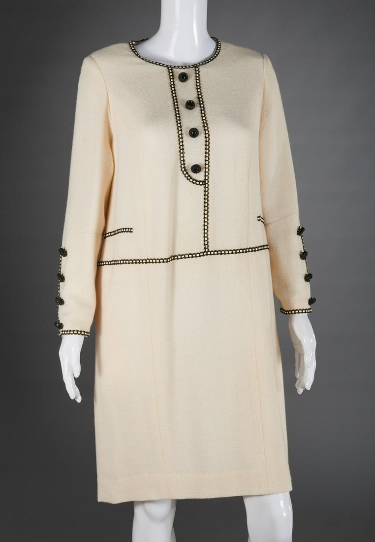 Ladies Akira Isogawa ivory boucle dress: Ladies Akira Isogawa ivory boucle dress, late 20th c., chemise style with button and leather trim in style of Chanel, approx. 37"b, 15"sh, 22"sl, 39"l Provenance: From the Florence and Herbert Irving 