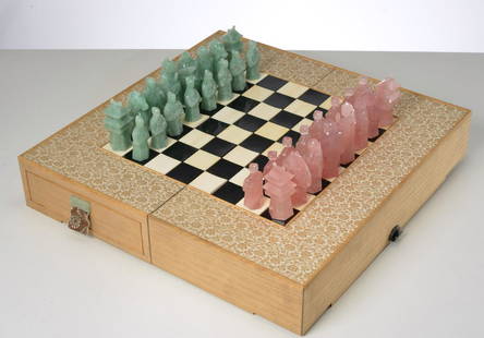 Japanese chess set with carved quartz pieces: Japanese chess set with carved quartz pieces, 20th c., incl. a folding wooden chess board, fitted with velvet lined drawers containing a complete set of pink and green carved quartz figural and pagoda