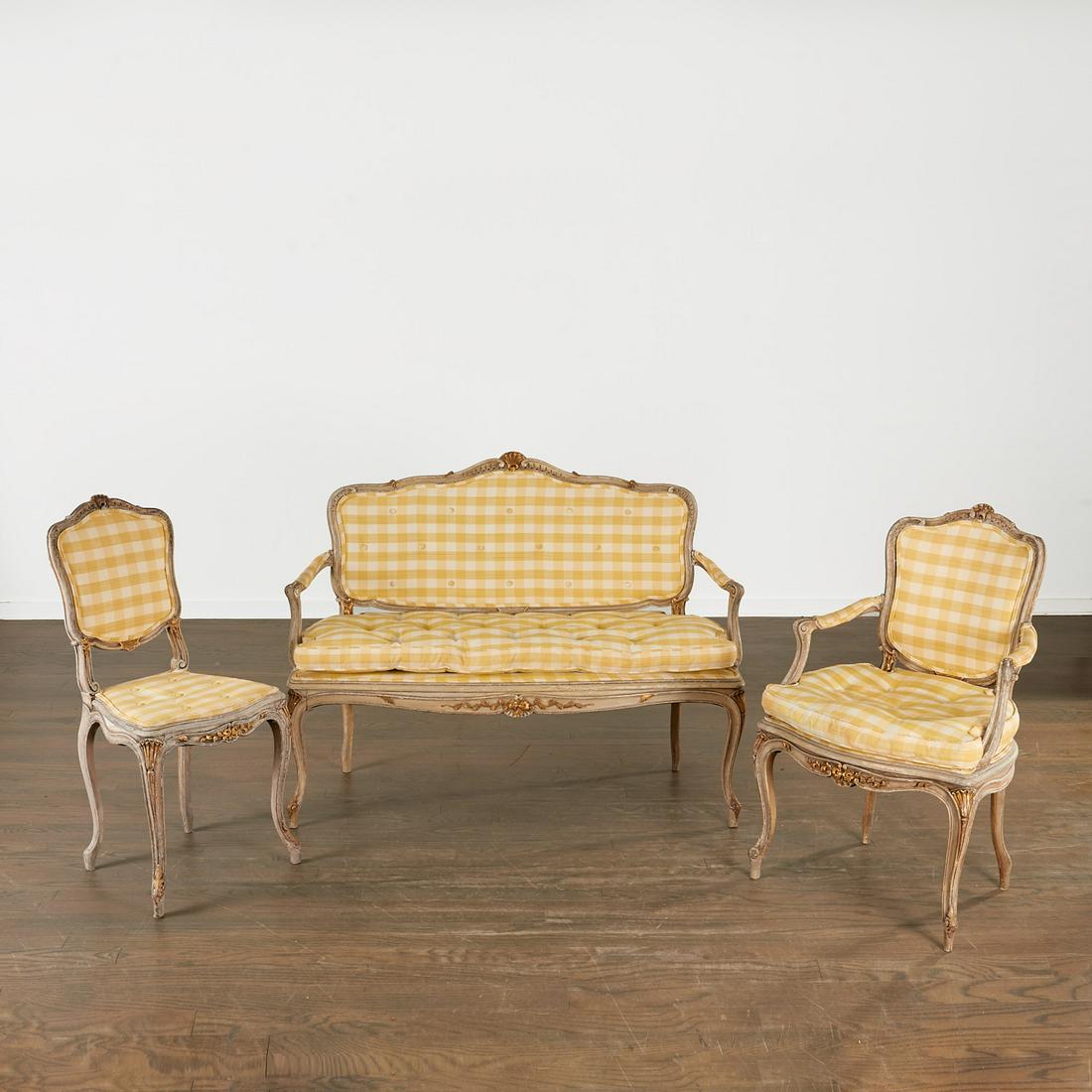 Antique Louis XV style gilt, painted seating suite: Antique Louis XV style gilt, painted seating suite, 19th c., France, gilt and cream painted channel carved beechwood frames, including a settee, a fauteuil, and a side chair, decorated with carved sea