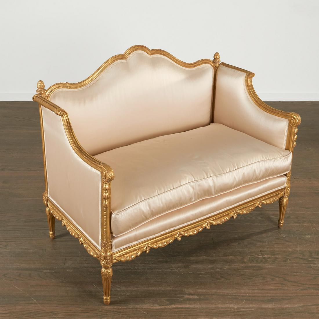 Nice Louis XVI style giltwood settee: Nice Louis XVI style giltwood settee, 20th c., thickly gilt carved wood frame, decorated with bellflowers along the skirt and arm, the shaped back set with pinecone finials, upholstered in an iridesce