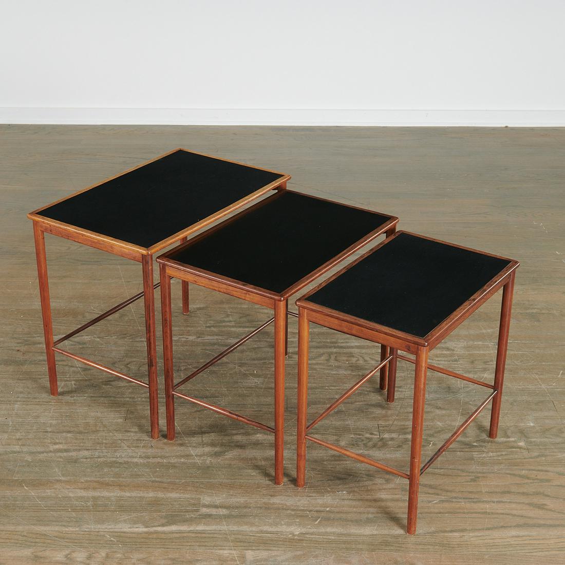 Grete Jalk, (3) hardwood nesting tables: Grete Jalk, (3) hardwood nesting tables, c. 1960, Danish, with black laminate inset tops, for Poul Jeppesen, Danish control stamp to underside of smallest table, 20"h x 28"l x 14.5"w (largest) Provena