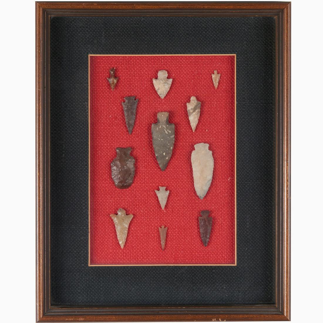 (12) Indian stone projectile points in display: (12) Indian stone projectile points in display, Arrowheads mounted and framed, smallest: 1"l, largest: 2.75"l, 15"h x 12"w x 2"d (frame)
