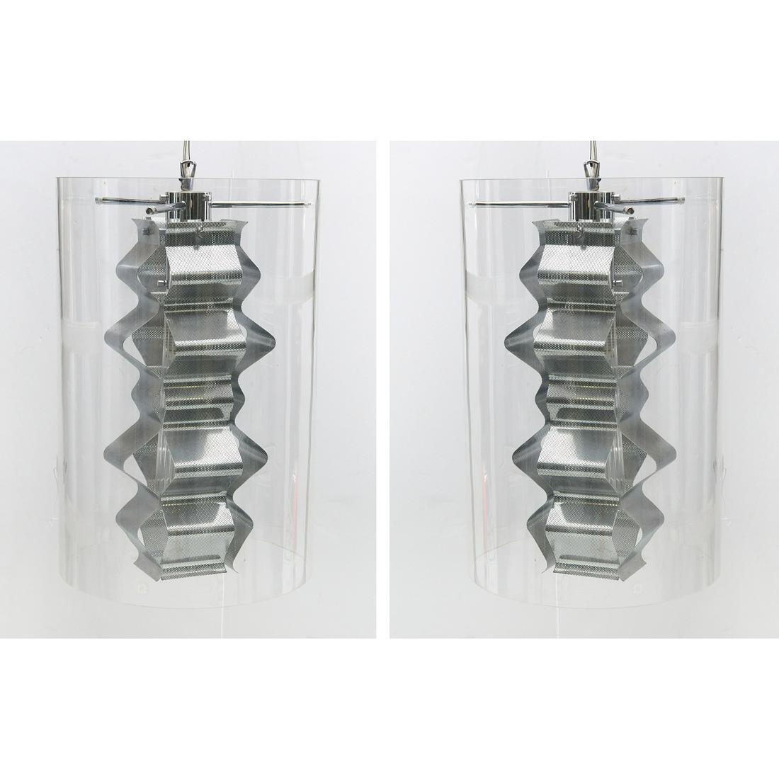 Pair Leucos cylinder pendant light fixtures: Pair Leucos cylinder pendant light fixtures, 21st c., chromed metal and colorless glass, manufacturer's label to side, 18.75"h x 12.5"dia (glass shade), approx. 58"h (total)