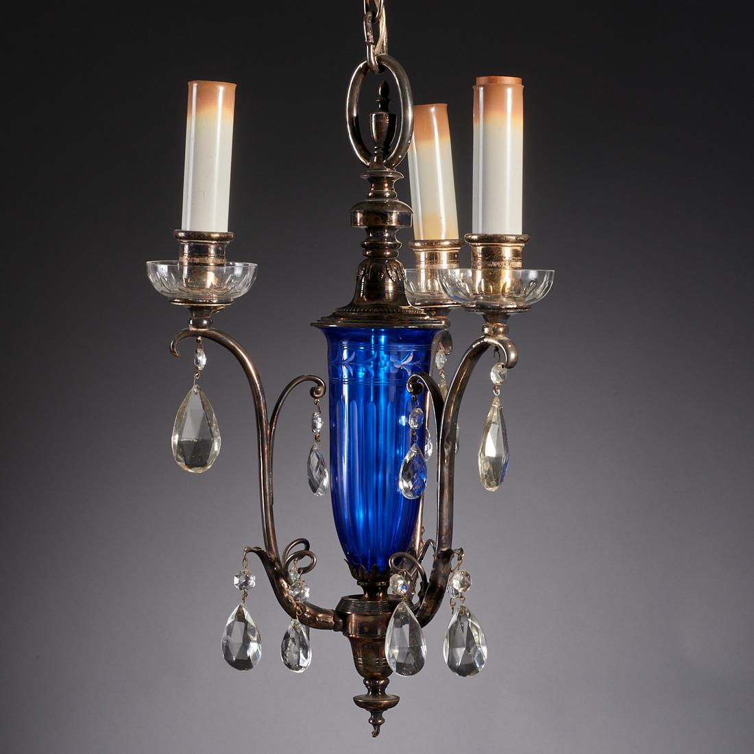 Regency style silver plated 3-light chandelier: Regency style silver plated 3-light chandelier, 20th c., wheel cut cobalt blue stem, the three scrolling arms topped with candlestick lights and etched clear glass bobeche, with crystal drops, 37"h x 