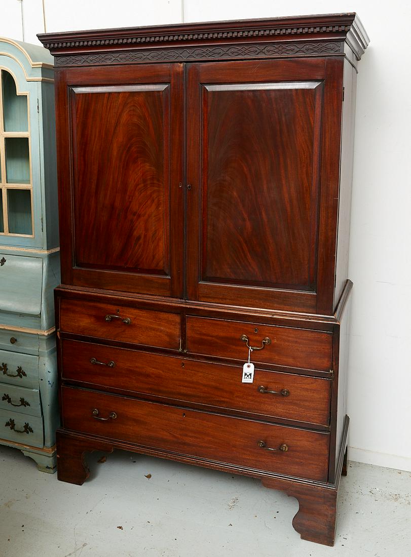 George III mahogany linen press: George III mahogany linen press, 19th c. (and later adapted), figured mahogany two-door cabinet with dental molding, above a four-drawer case (two drawers converted to drop front compartments) with br