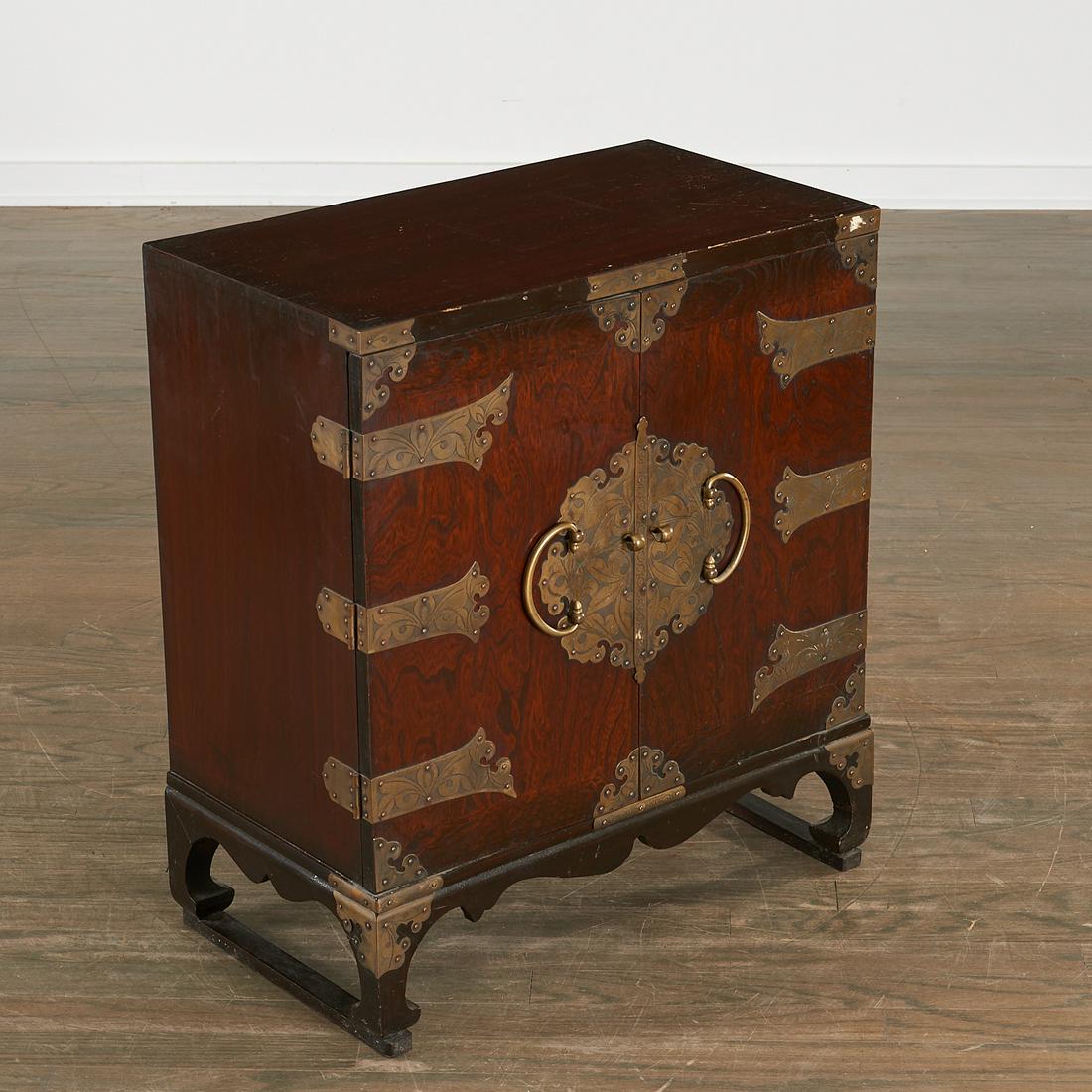 Korean brass mounted hardwood chest: Korean brass mounted hardwood chest, 19th c., dark stained elm, incised decorated brass, the two doors opening to shelves and fitted drawers, 24.5"h x 21.5"w x 12"d