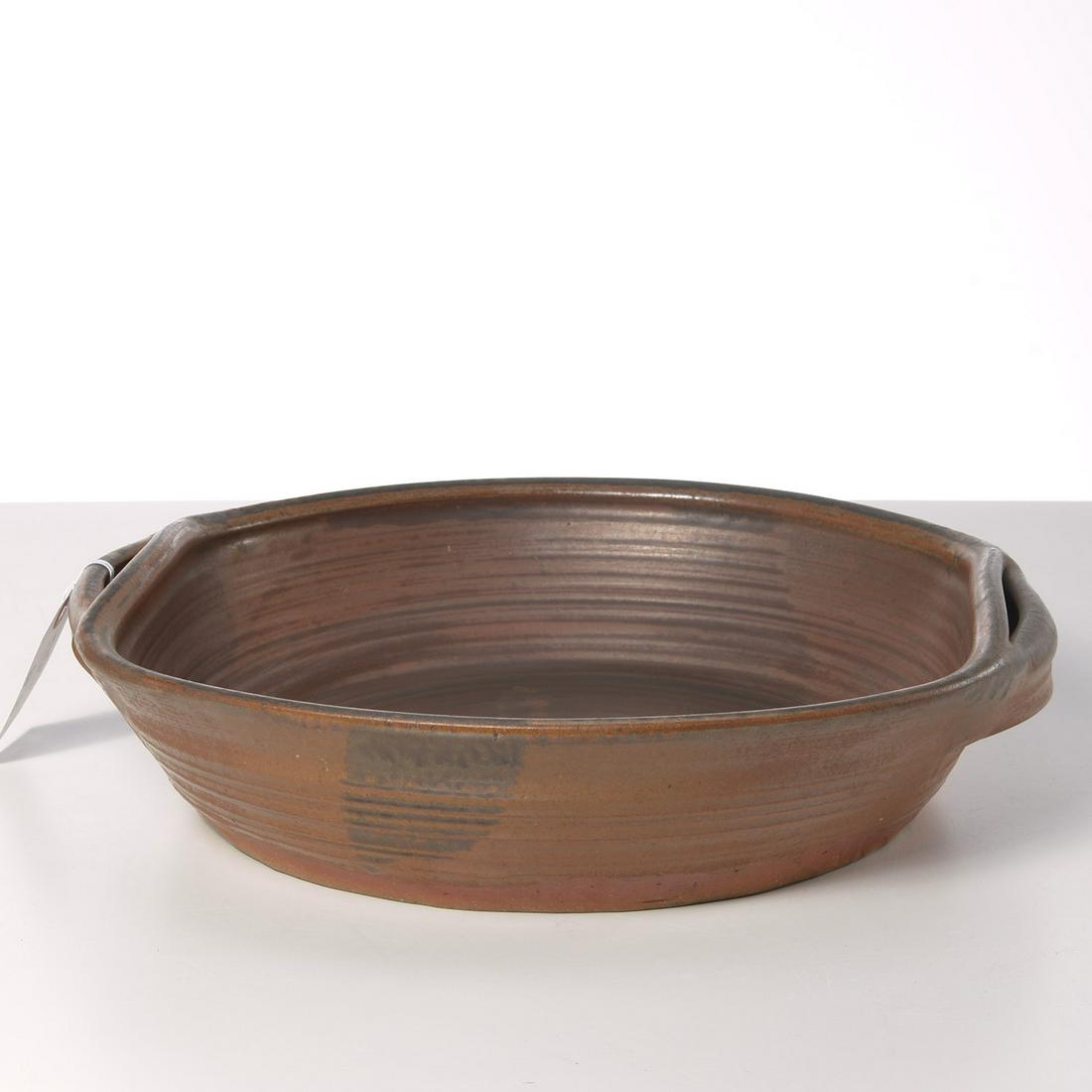 Karen Karnes, glazed stoneware serving bowl: Karen Karnes, glazed stoneware serving bowl, Karen Karnes (American, 1925-2016), artist cipher on bottom edge, 4"h x 15"w x 14.5"d Provenance: Property removed from 1240 Park Avenue, NYC