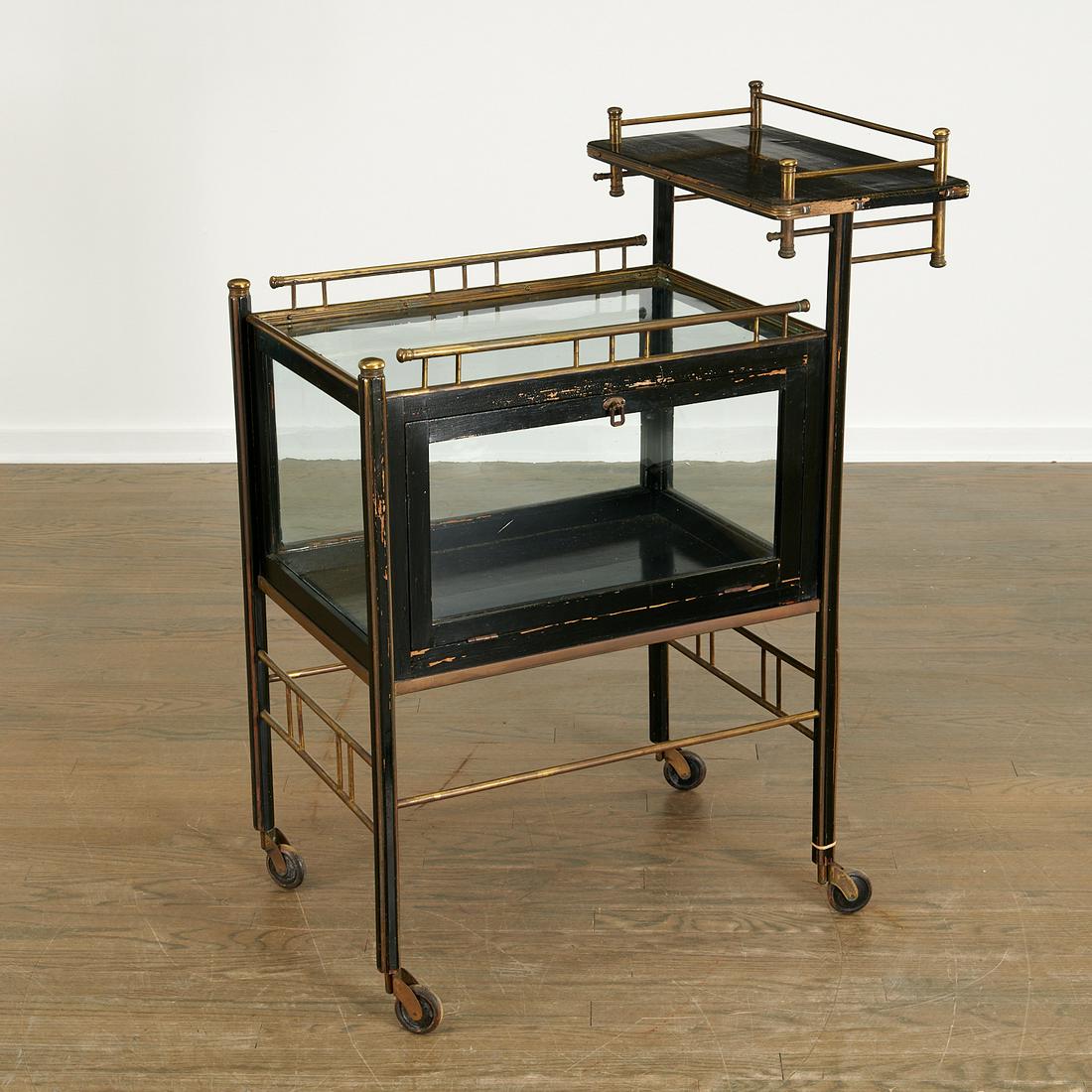 Ernst Rockhausan (attrib.), tiered serving cart: Ernst Rockhausan (attrib.), tiered serving cart, c. 1910, Germany, lacquered wood, brass, glass, on casters, three-tiered trolley with glass-enclosed vitrine case, unsigned, 40"h x 31"l x 19"w Provena