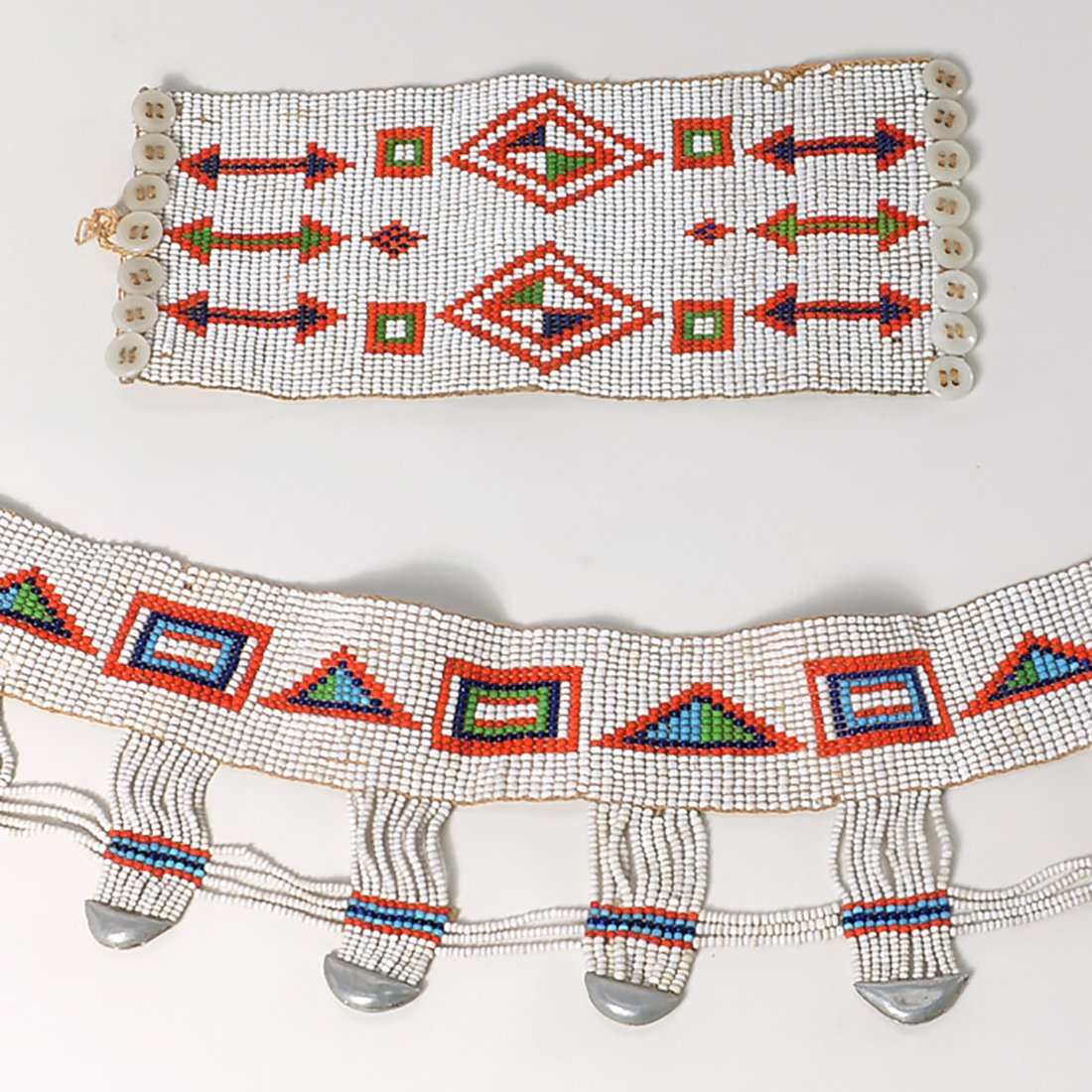 Tribal beaded belt and bracelet: Tribal beaded belt and bracelet, First half 20th c., incl. a wide arm cuff bracelet and small (child's?) belt, with dangling silvertone bell beads, 4.25"h x 25.5"l (belt), 3.75"h x 8.75"l (cuff)
