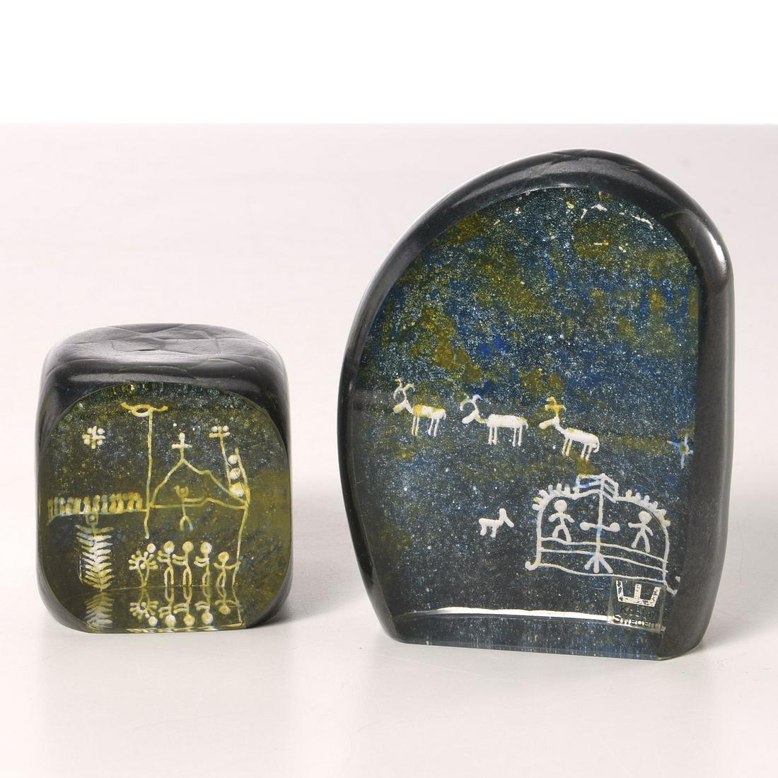 Goran Warff for Kosta, (2) art glass paperweights: Goran Warff for Kosta, (2) art glass paperweights, 20th c., Swedish, Lapland Series, etched cave art decoration, each signed on underside, larger with sticker label, 4.5"h x 3.5"w x 1.5"d (larger), 2.
