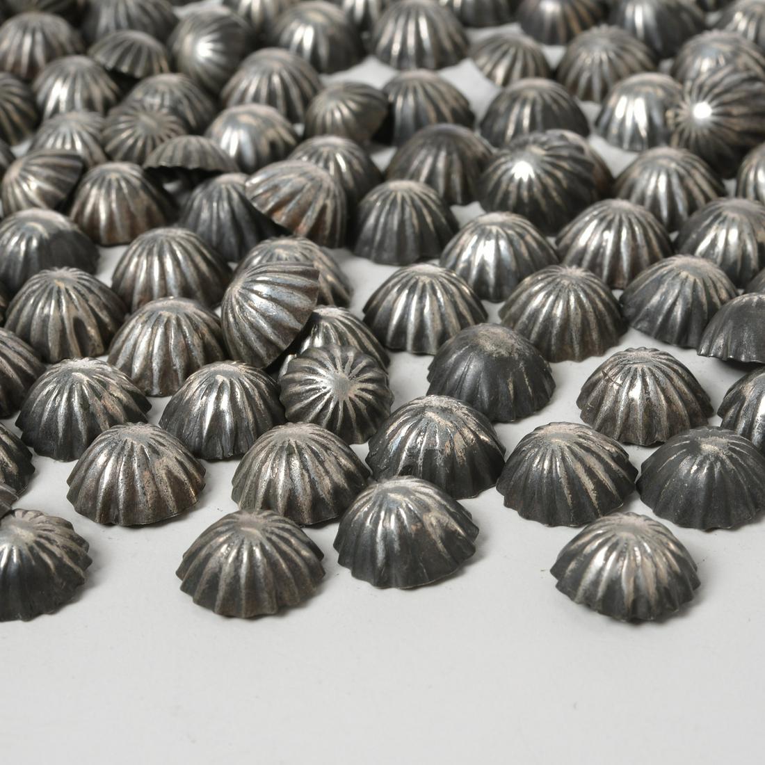 Collection vintage Navajo coin silver buttons: Collection vintage Navajo coin silver buttons, Mid 20th c., ornamental buttons and conchas, including fluted domes, unmarked (silver content unknown), most buttons with coiled copper hooks, approx. 27