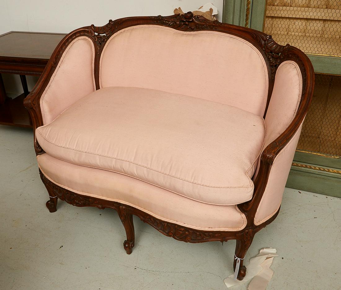 Louis XV style carved walnut canape: Louis XV style carved walnut canape, 19th c., France, carved with scrolling acanthus leaves and a rose-cluster crest, upholstered in pink raw silk, 35"h x 45"l x 22"d (settee) Provenance: The Collecti