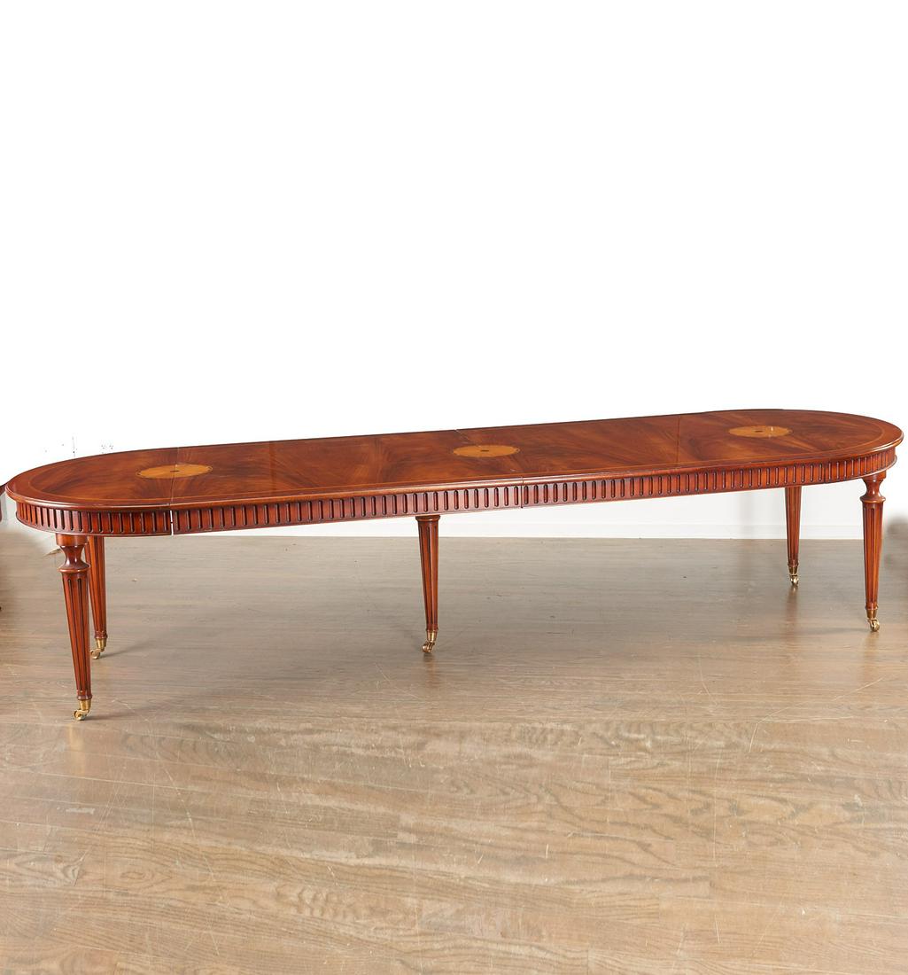 Louis XVI style mahogany extension dining table: Louis XVI style mahogany extension dining table, 20th c., retailed by Manor House, round figured walnut top with central inlaid veneer fan medallion, raised on tapered channel carved legs and brass ca