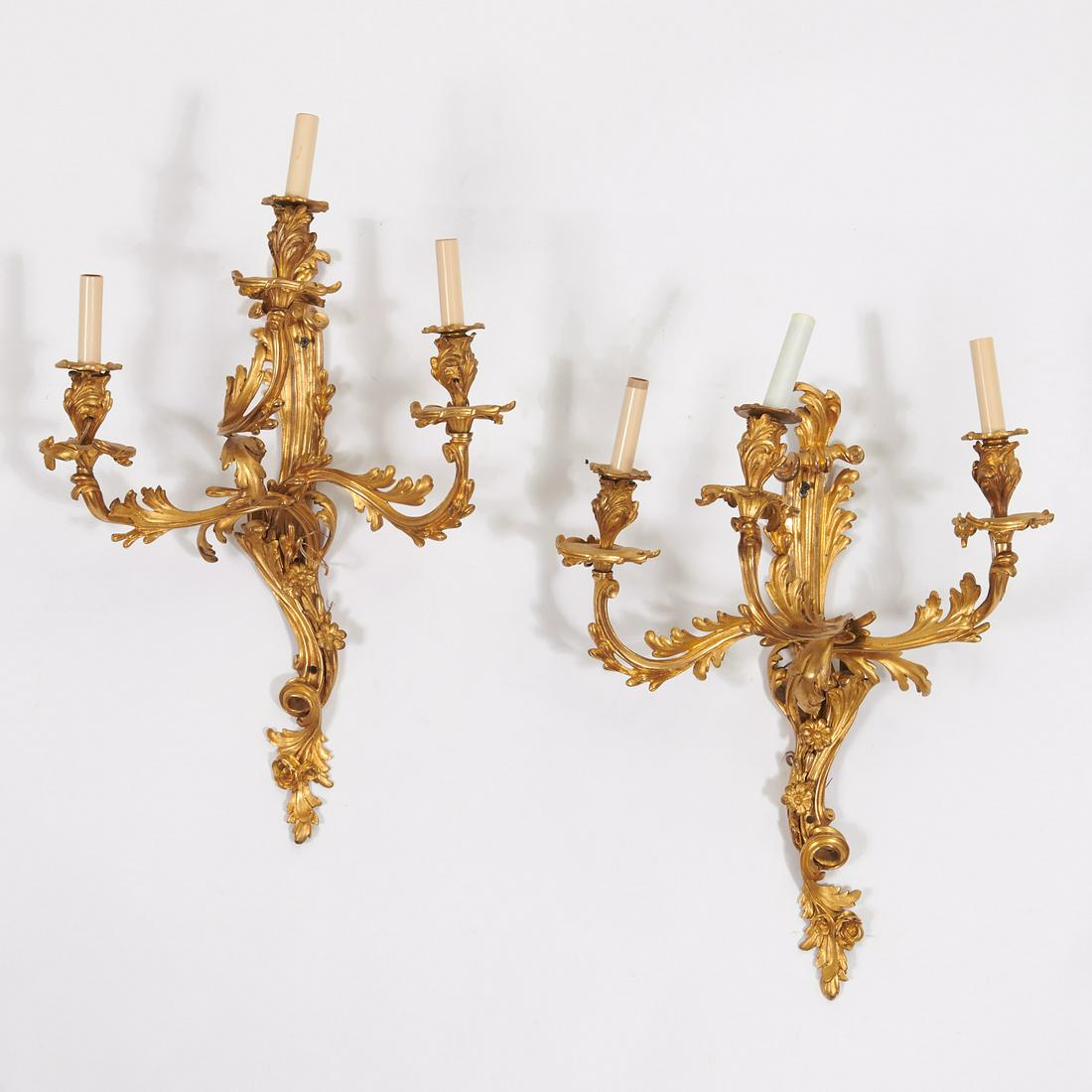 Pair large Louis XV ormolu three-arm sconces: Pair large Louis XV ormolu three-arm sconces, 19th c., in two parts, each with an acanthus backplate and three scrolling branch arms, illegible stamped initial to one example, 23"h x 20"w x 14"d Prove